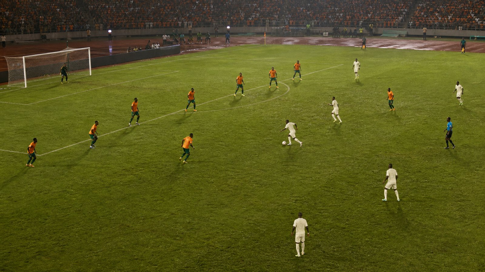 Compact copper-orange football team defending in two disciplined lines