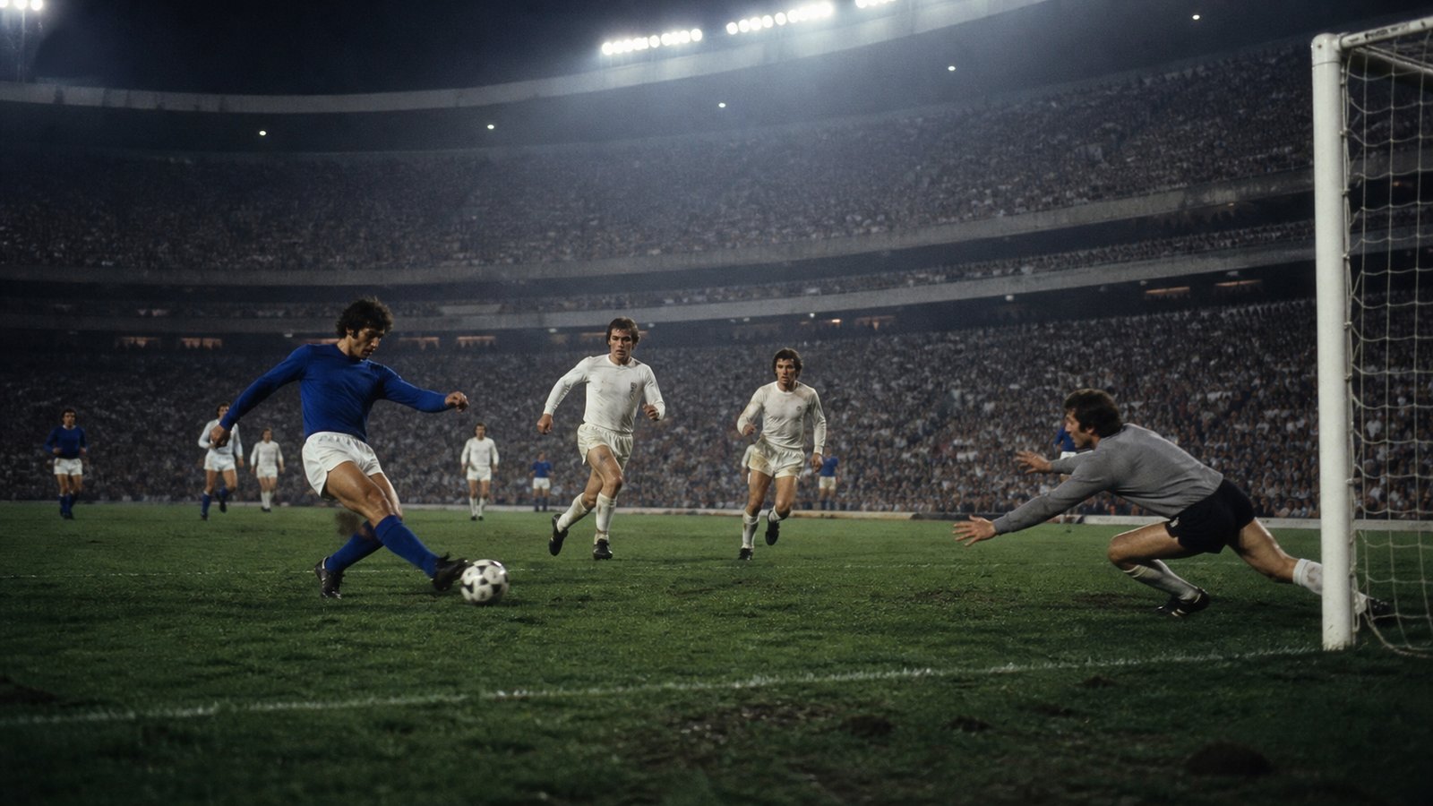 Italian forward shooting low through a closing West German defence in a floodlit 1970 stadium
